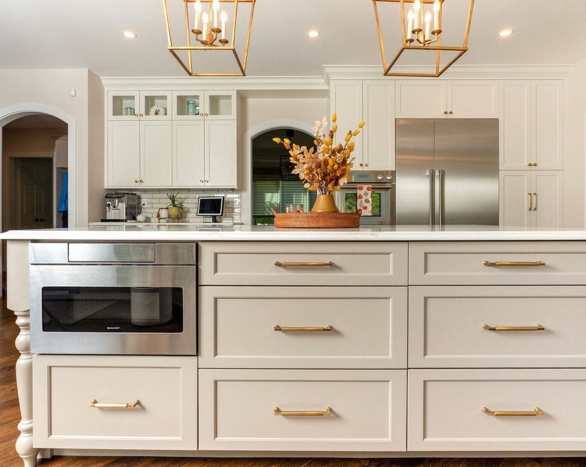 slide out microwave on kitchen island with drawers and stainless steel appliances