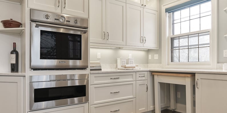 classic white kitchen with lots of storage and a butchers block nook