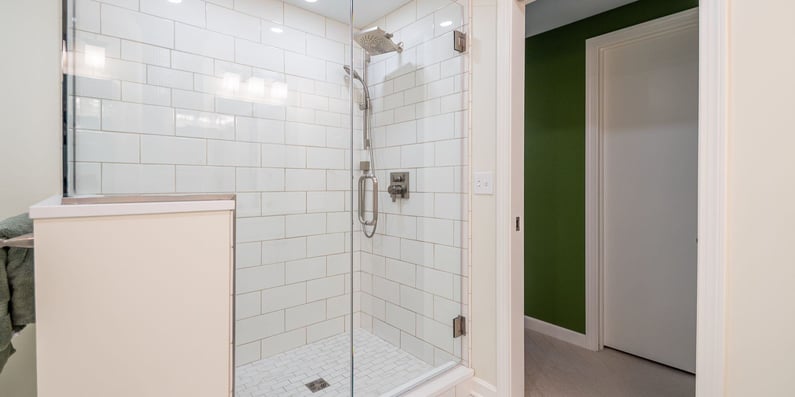 glass door shower with white tile in a Cleveland bathroom remodel