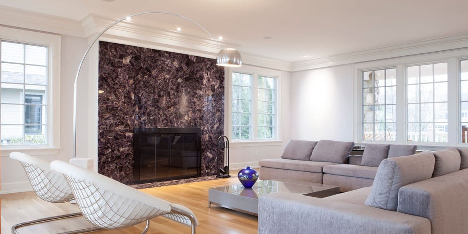 sleek, modern home remodel in cleveland heights ohio with marble fireplace, modern lighting and furniture and white walls and light wood floors