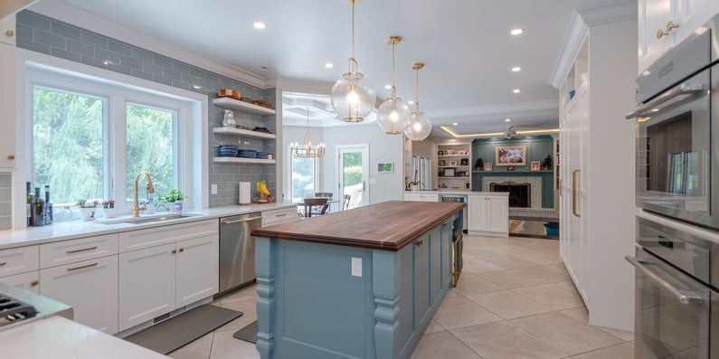 Solon Ohio kitchen renovation with white cabinets, blue kitchen island, and open shelving