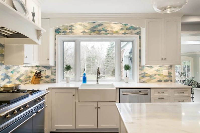 Kitchen renovation in Pepper Pike Ohio with white cabinets and blue and green backsplash