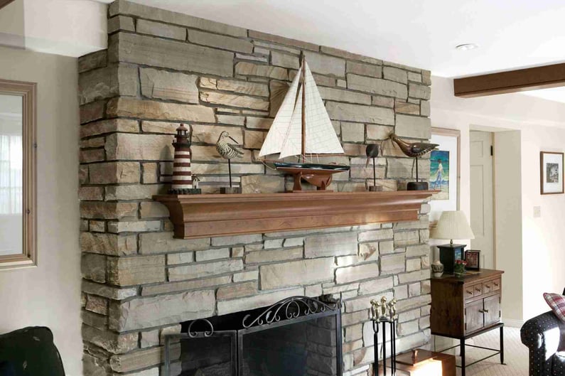 Basement Remodel in Cleveland Area with Stone Fireplace and Exposed Beams