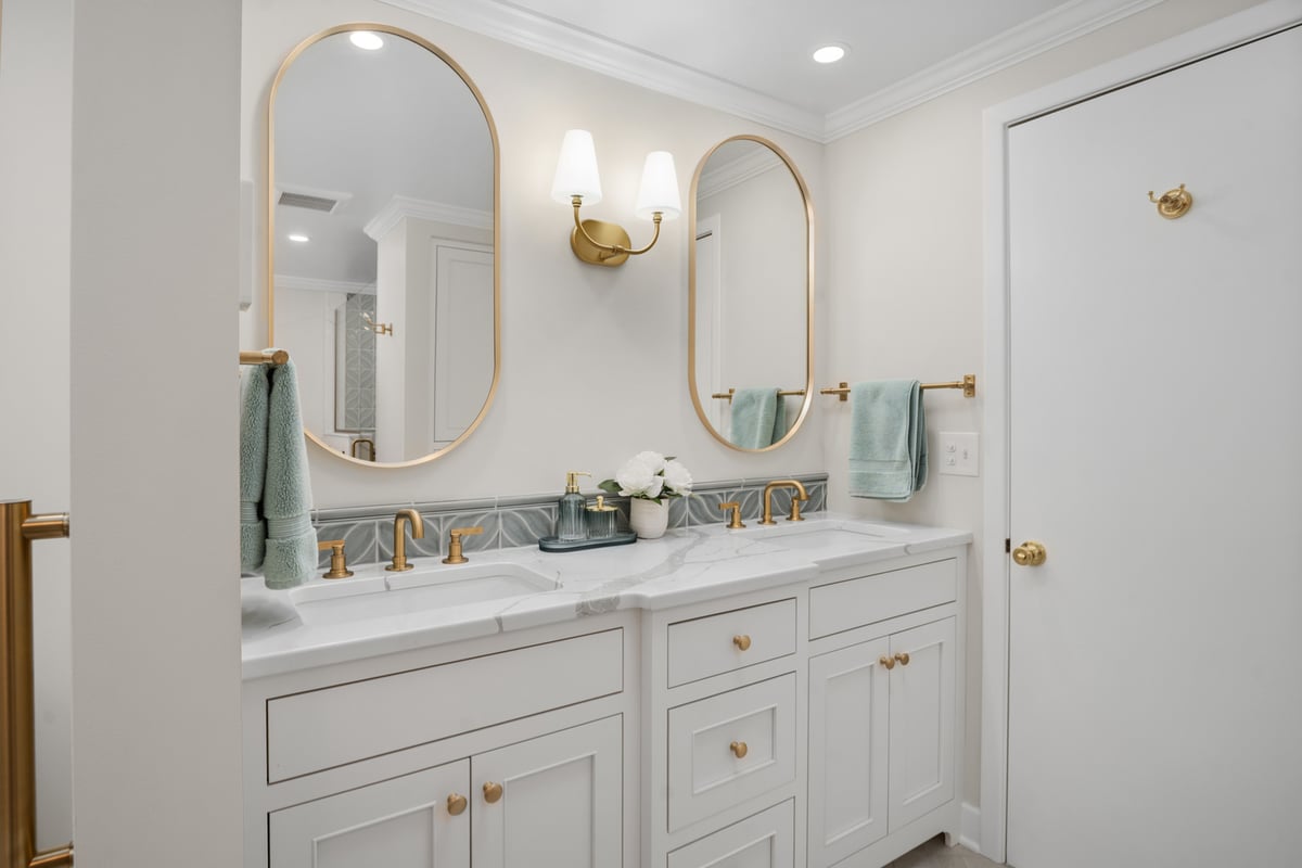 double vanity bathroom remodel with arched mirrors and gold fixtures by Chagrin River Company in Kirtland, OH