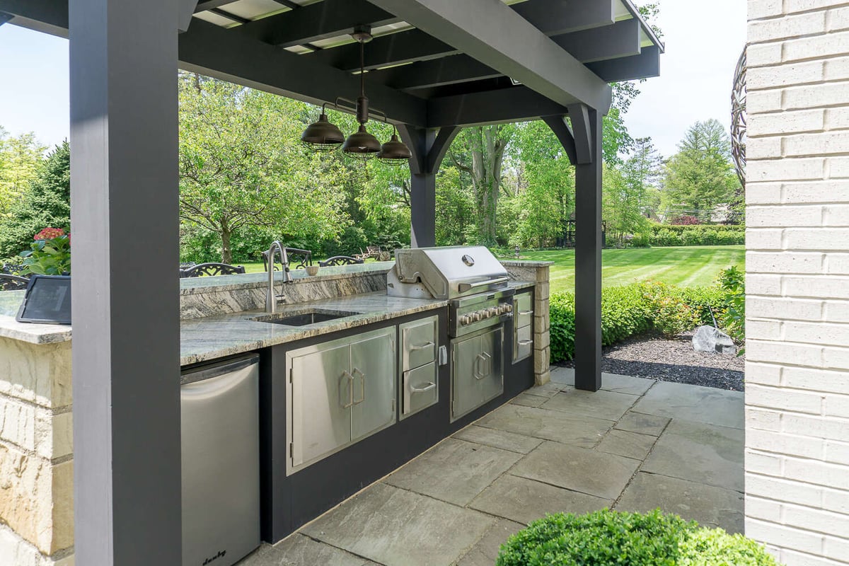 exterior remodel featuring built-in grill and outdoor cabinetry by Chagrin River Company in Pepper Pike, OH