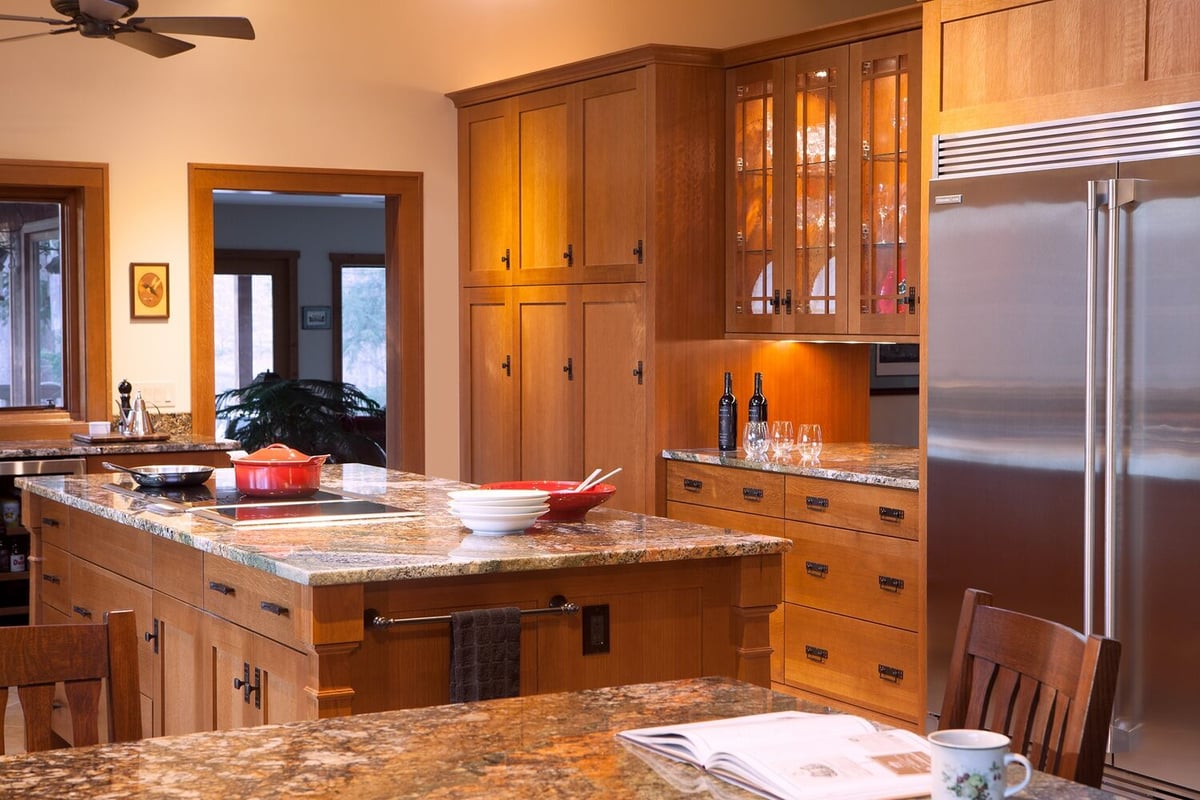 custom kitchen with stainless steel refrigerator and island workspace by Chagrin River Company in Chagrin Falls, OH