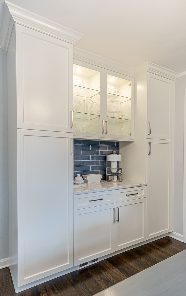 detailed custom home cabinetry in Euclid, OH by Chagrin River Company with illuminated glass cabinets and hardwood flooring.