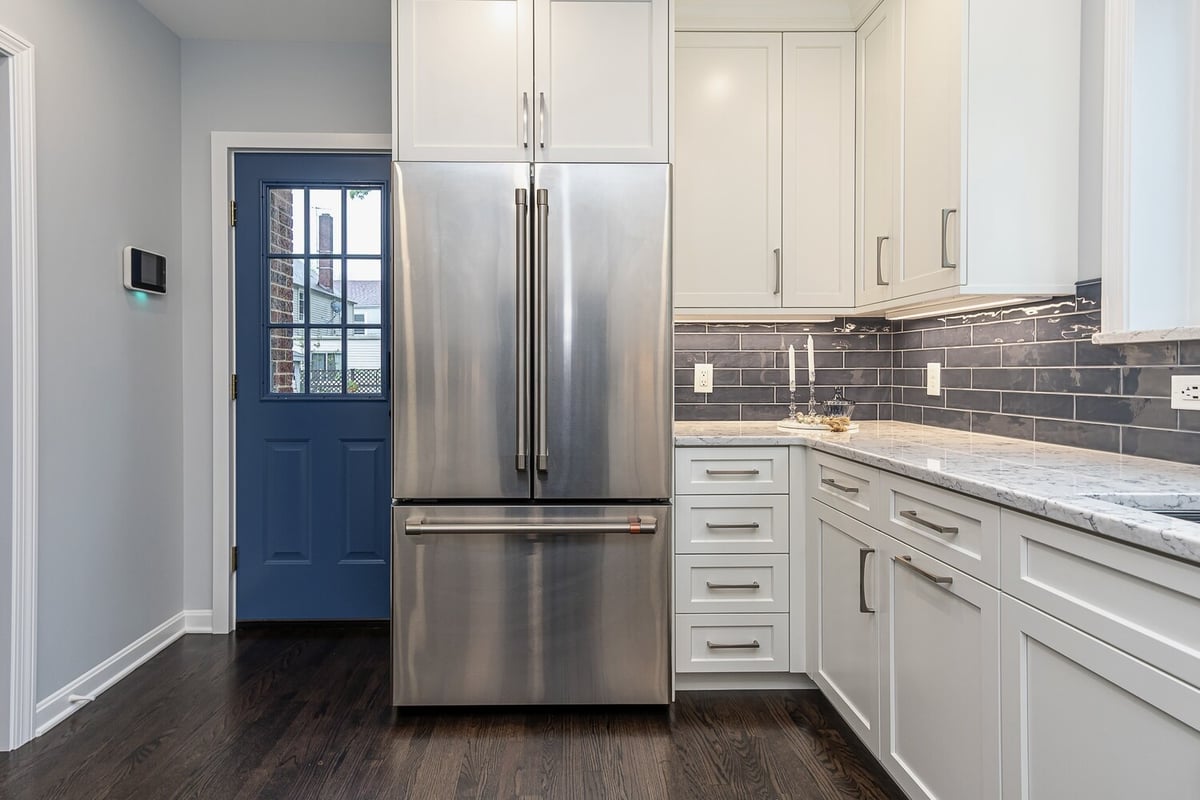 modern custom home kitchen in Euclid, OH built by Chagrin River Company with built-in cabinetry and hardwood floors.