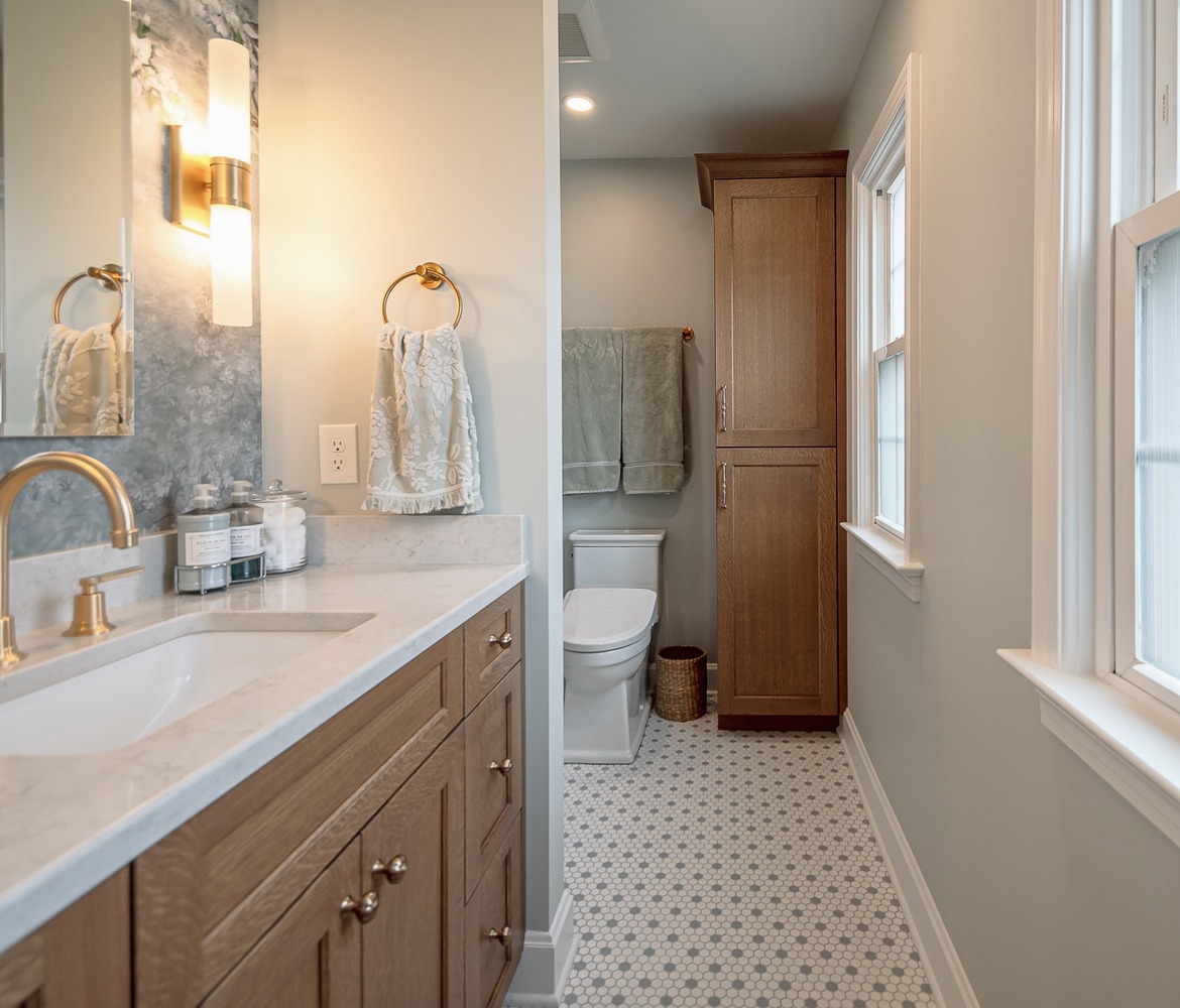 Shaker Heights, OH custom home bathroom built by Chagrin River Company with hex tile floor and windowed wall.