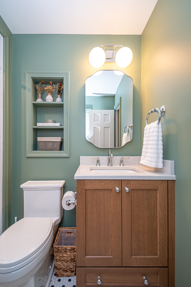 modern custom home bathroom design by Chagrin River Company in Shaker Heights, OH with built-in shelving and hex tile floor.