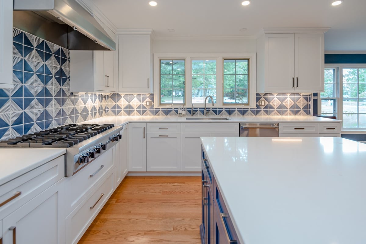 Pepper Pike, OH custom home kitchen built by Chagrin River Company featuring quartz countertops and geometric tile backsplash.