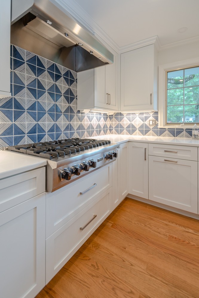 Pepper Pike, OH custom home kitchen built by Chagrin River Company with Viking gas range and patterned blue tile backsplash.