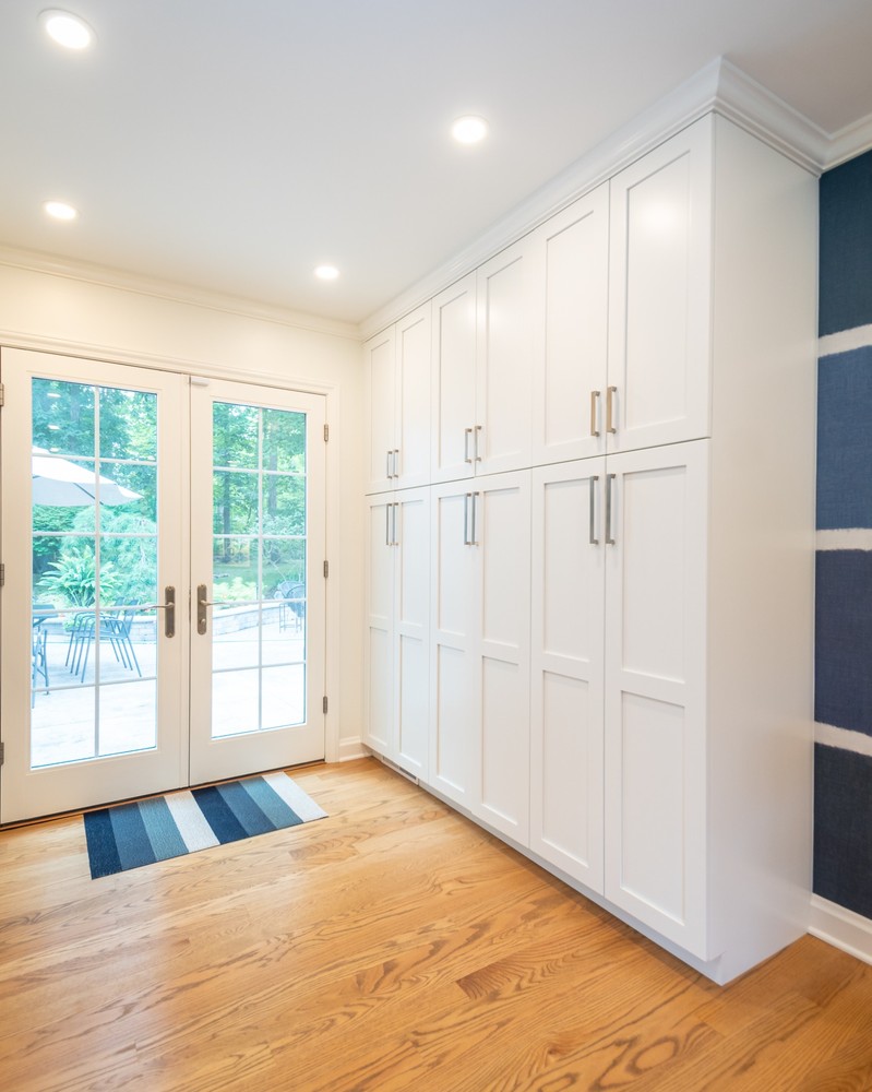 custom home entryway cabinetry by Chagrin River Company in Pepper Pike, OH with recessed lighting and patio access.