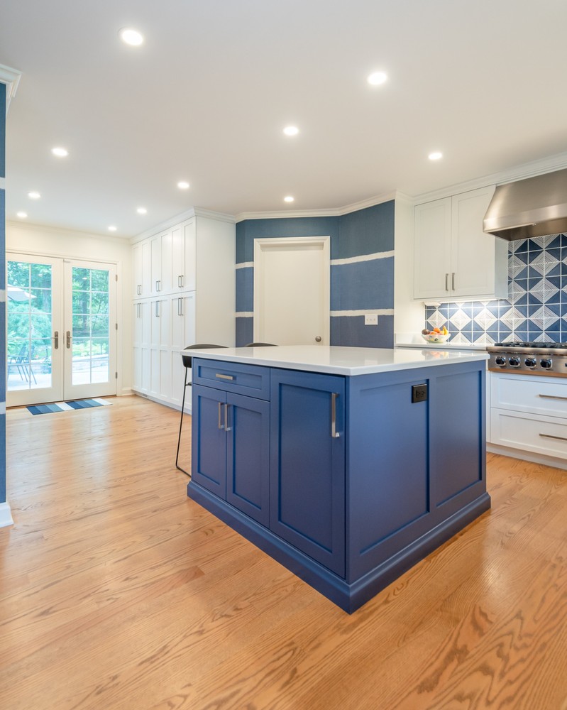 custom home kitchen by Chagrin River Company in Pepper Pike, OH featuring blue island and white cabinetry.