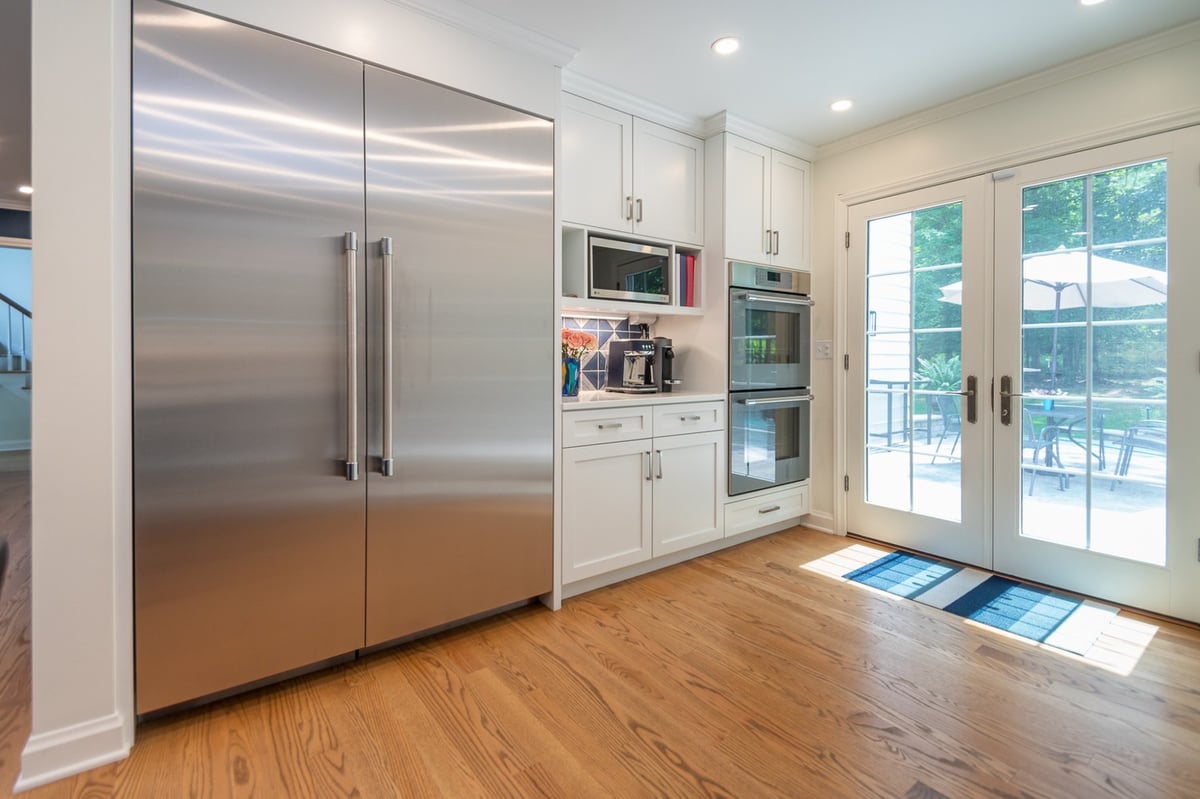 custom home kitchen by Chagrin River Company in Pepper Pike, OH with stainless steel refrigerator and double ovens.