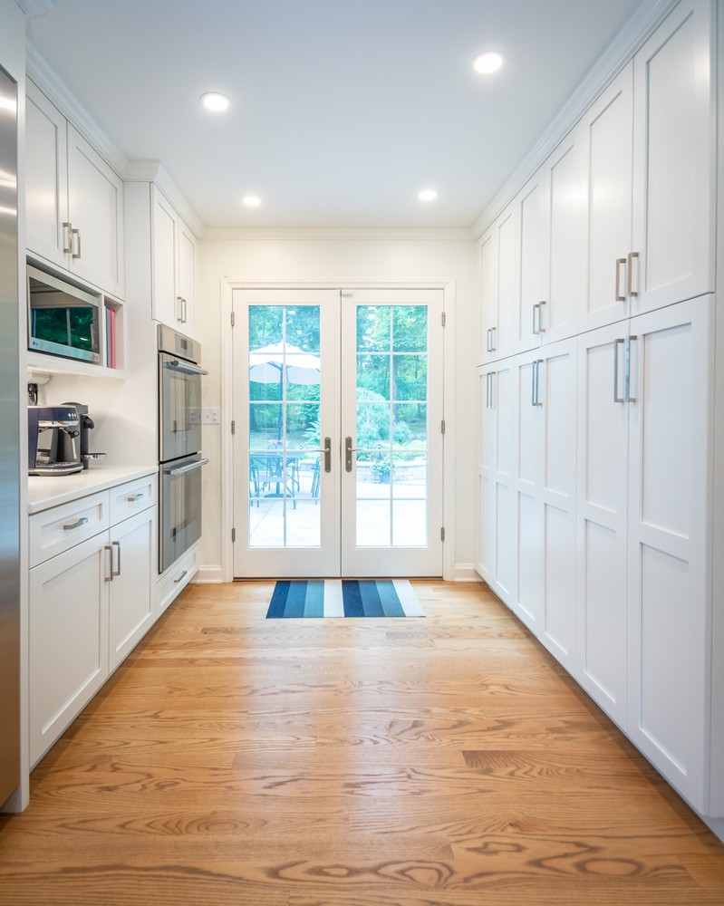 modern custom home kitchen layout by Chagrin River Company in Pepper Pike, OH with French doors to patio.