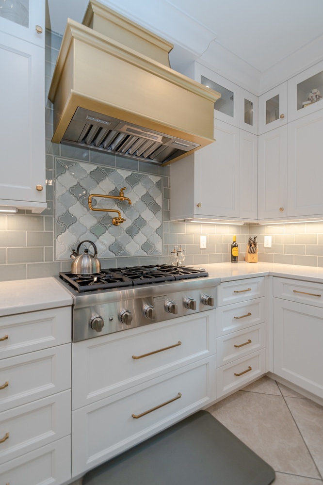 Solon, OH custom home kitchen with stainless range and brass accents by Chagrin River Company