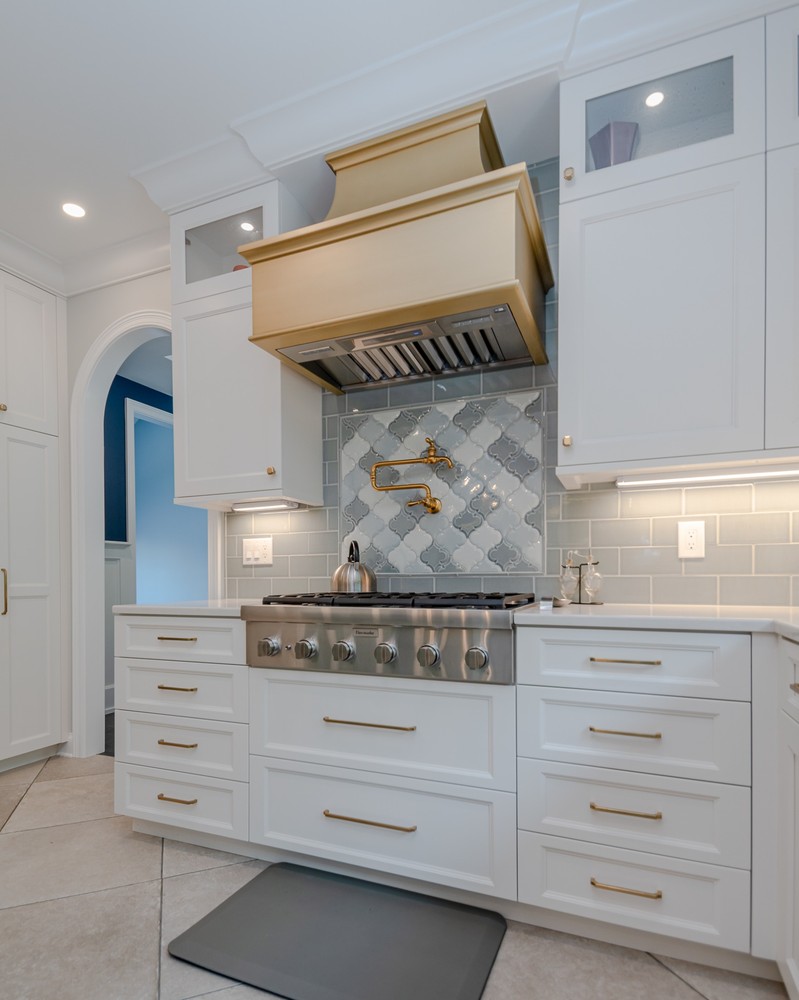 custom home kitchen range with gold hood by Chagrin River Company in Solon, OH