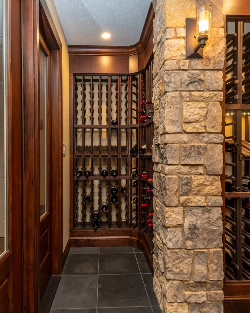 detailed custom home wine room with wood shelving by Chagrin River Company in Solon, OH
