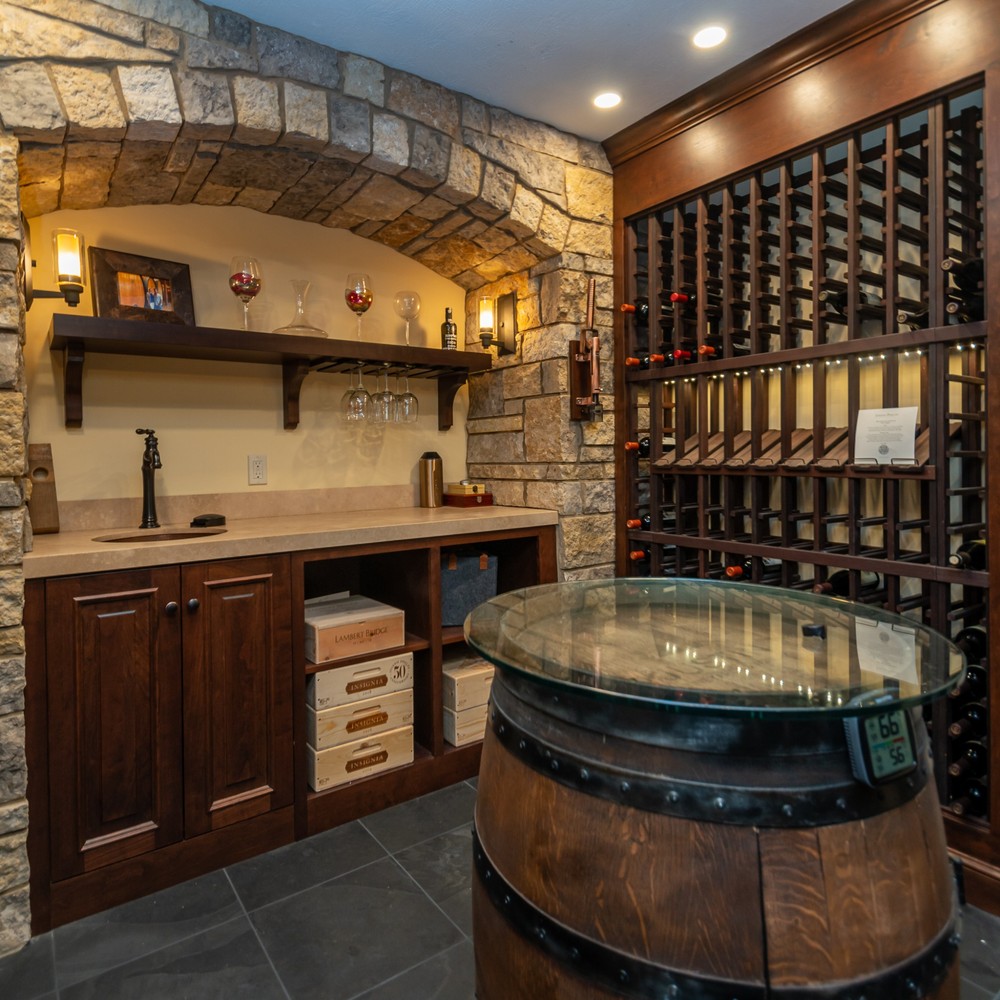 luxury custom home wine room with barrel table by Chagrin River Company in Solon, OH