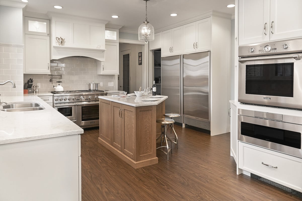 custom home kitchen with white cabinetry and wood island by Chagrin River Company in Chardon, Ohio