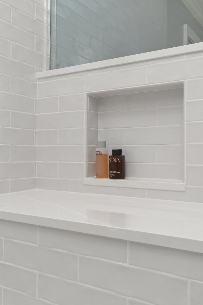 Chagrin River Company Shaker Heights bathroom featuring a recessed shower niche surrounded by white subway tile.-optimized