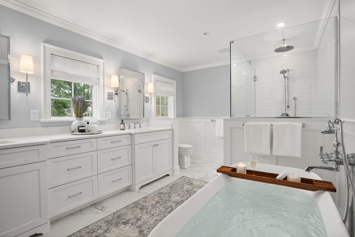 Chagrin River Company bathroom remodel in Shaker Heights featuring a filled soaking tub, glass shower, and double vanity.-optimized