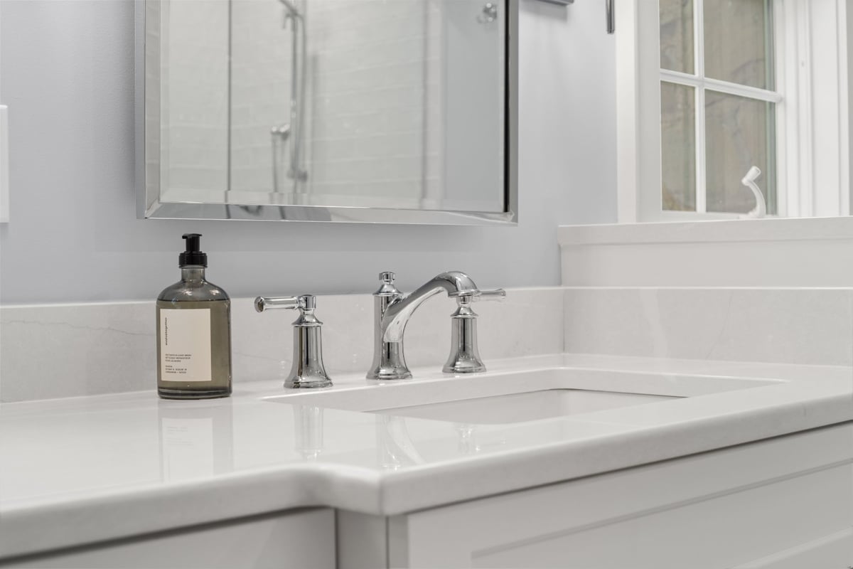 Chagrin River Company bathroom remodel in Shaker Heights featuring an undermount sink, white countertop, and polished chrome fau-optimized