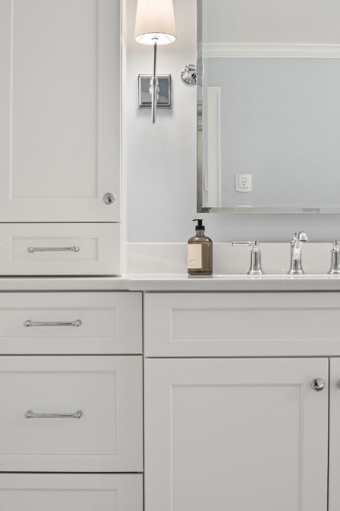 Chagrin River Company bathroom remodel in Shaker Heights featuring custom white vanity cabinetry, chrome hardware, mirror, and w-optimized