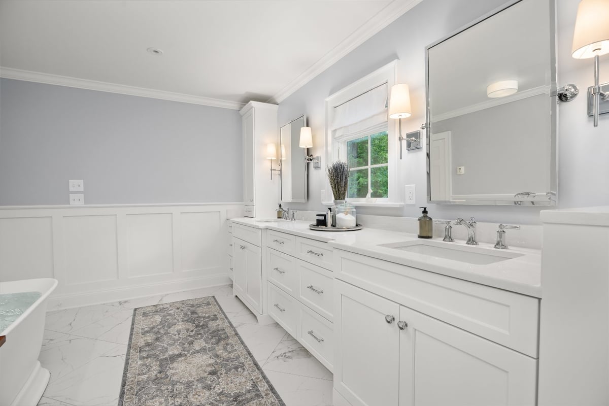 Chagrin River Company bathroom remodel in Shaker Heights with custom white double vanity, chrome fixtures, and paneled walls.-optimized