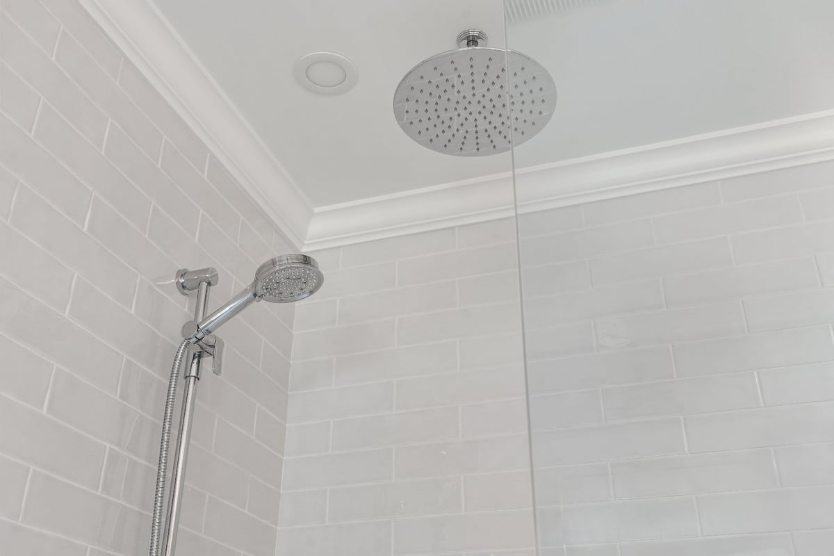 Chrome dual shower system and white subway tile in a Shaker Heights bathroom renovation by Chagrin River Company.-optimized