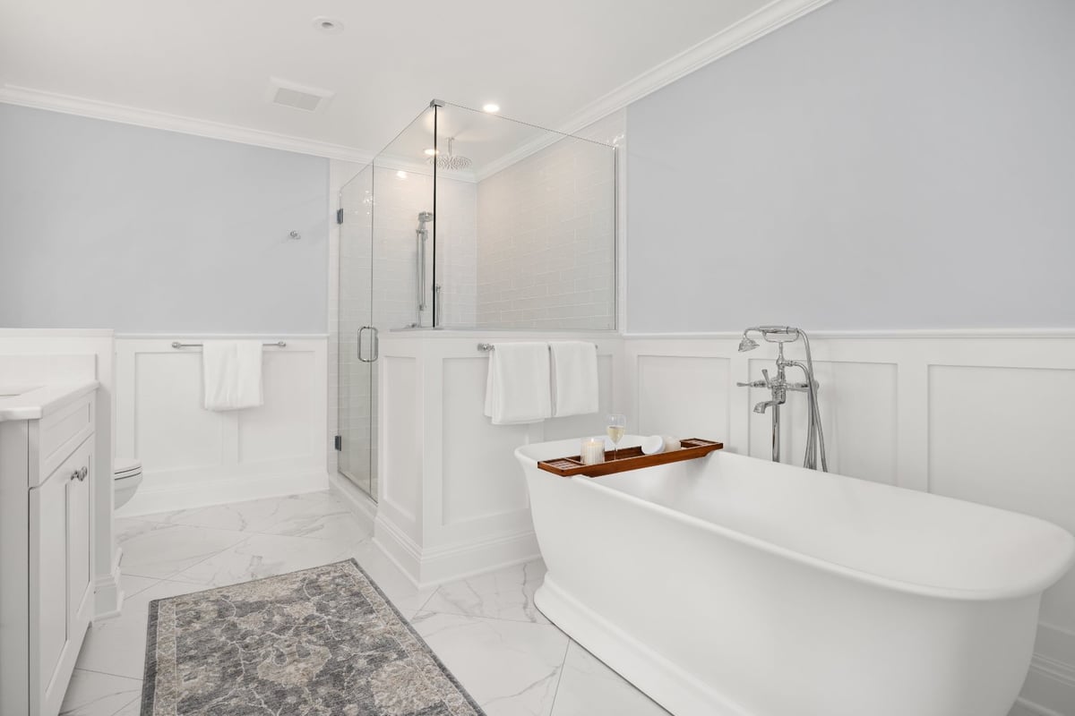 Shaker Heights bathroom by Chagrin River Company with a white freestanding tub, chrome tub filler, glass-enclosed shower, and tr-optimized