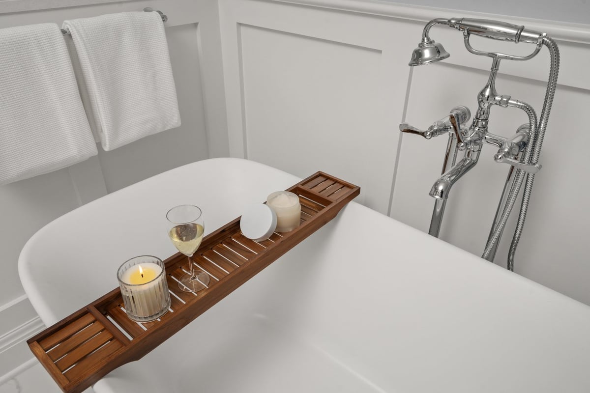 Shaker Heights bathroom renovation by Chagrin River Company with freestanding tub, chrome fixtures, and white paneled walls.-optimized