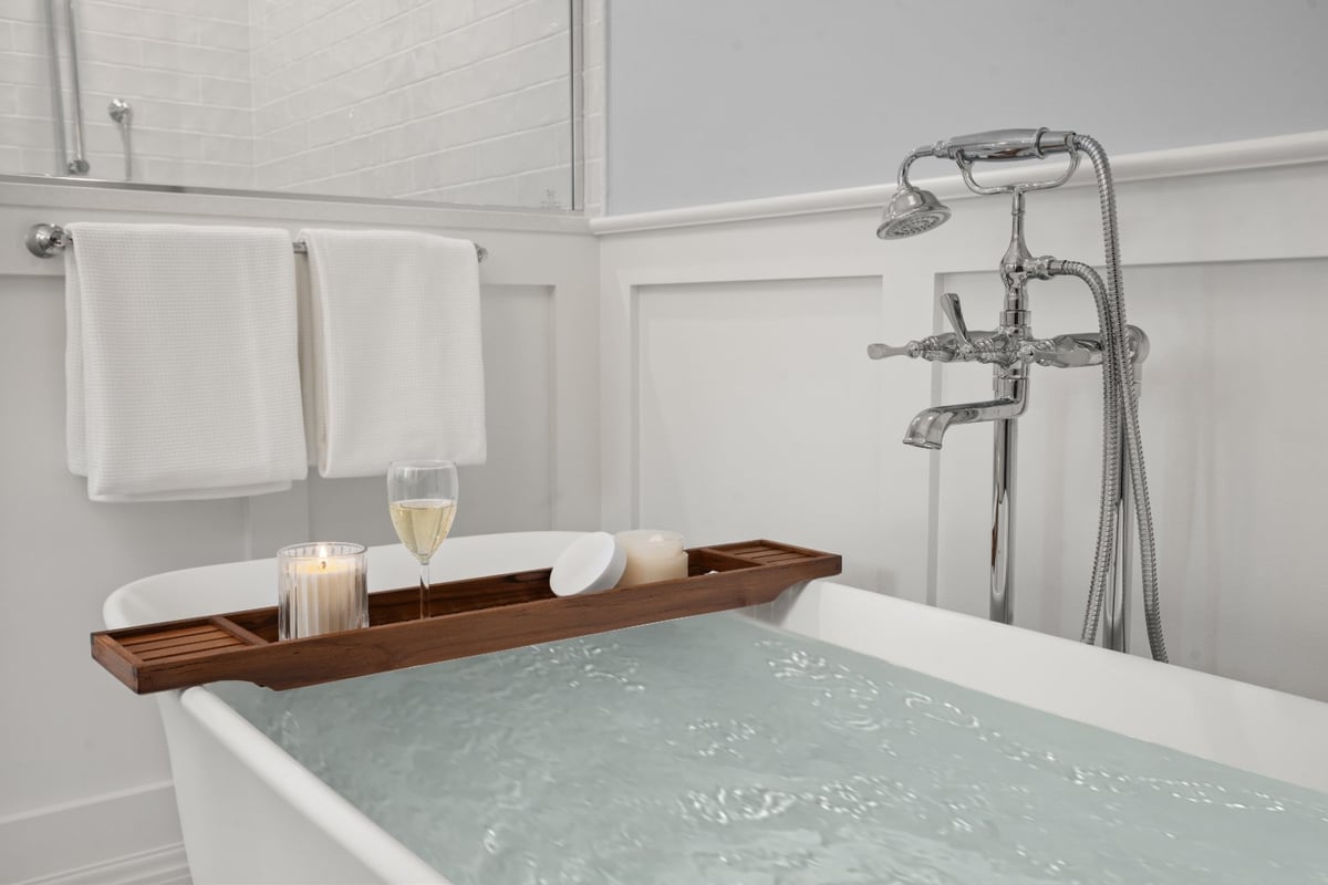 Shaker Heights bathroom renovation by Chagrin River Company with freestanding tub, polished chrome fixtures, and white wainscoti-optimized