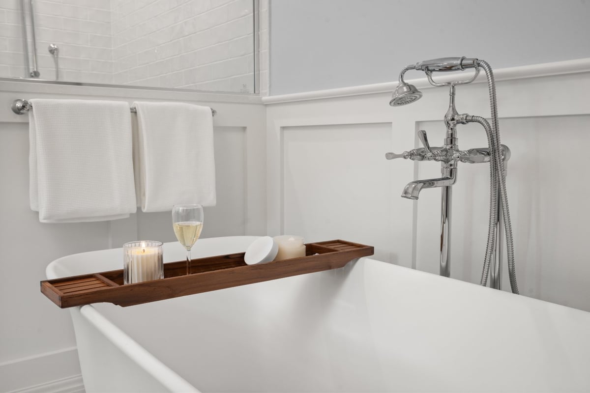 Shaker Heights bathroom renovation by Chagrin River Company with soaking tub, wood bath tray, and polished chrome fixtures.-optimized