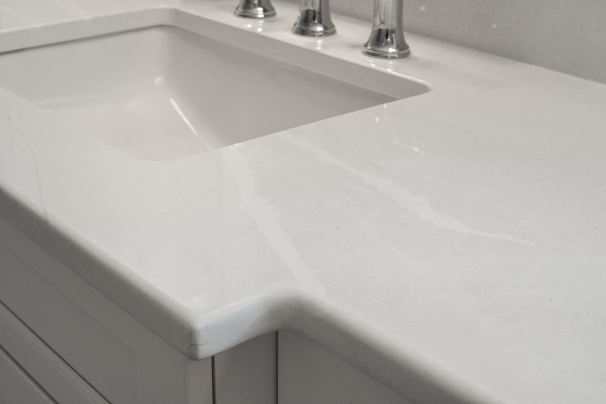 White bathroom vanity countertop and undermount sink detail by Chagrin River Company in Shaker Heights.-optimized