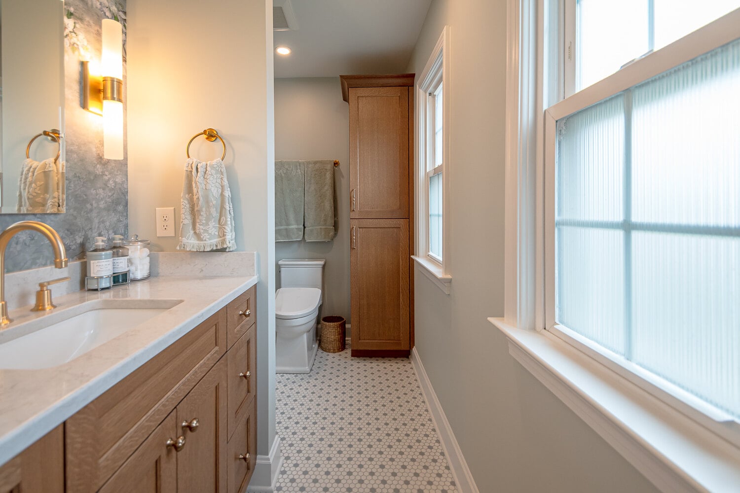 bathroom remodel with wood vanity and natural light window by Chagrin River Company in Pepper Pike, OH
