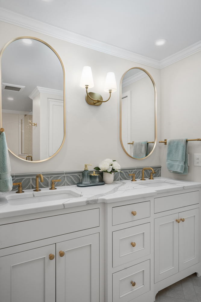 bathroom vanity detail with gold faucet and marble countertop by Chagrin River Company in Bainbridge, OH