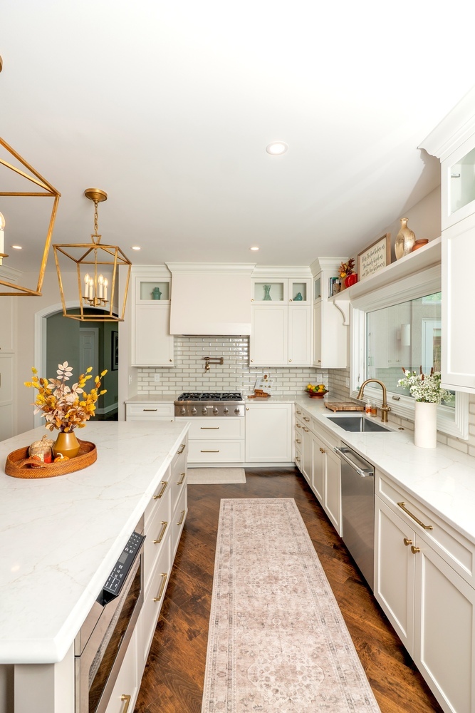 custom kitchen with white cabinets and gold fixtures by Chagrin River Company in Shaker Heights, OH