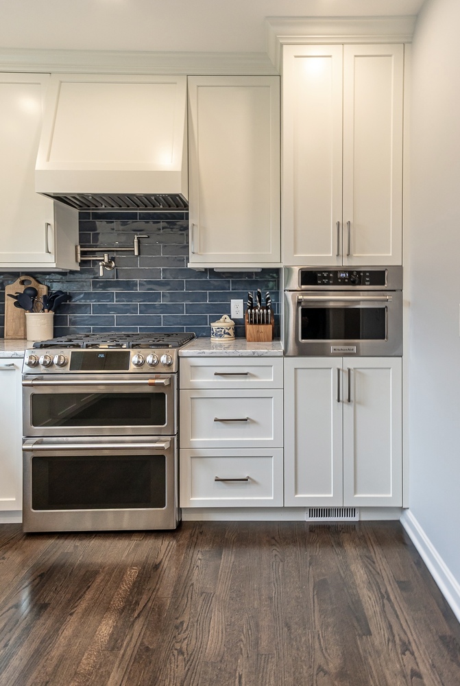 detailed custom home kitchen in Euclid, OH by Chagrin River Company showcasing stainless steel oven and blue backsplash.
