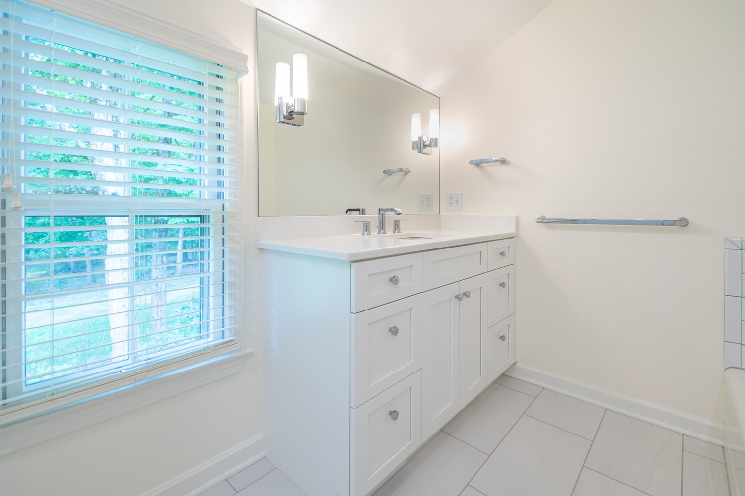 modern custom home bathroom design by Chagrin River Company in Pepper Pike, OH with clean white finishes.