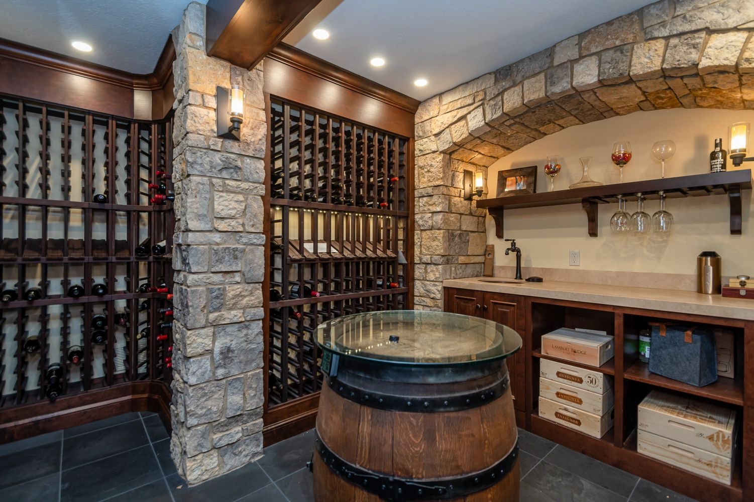luxury custom home wine cellar design with tasting table by Chagrin River Company in Solon, OH